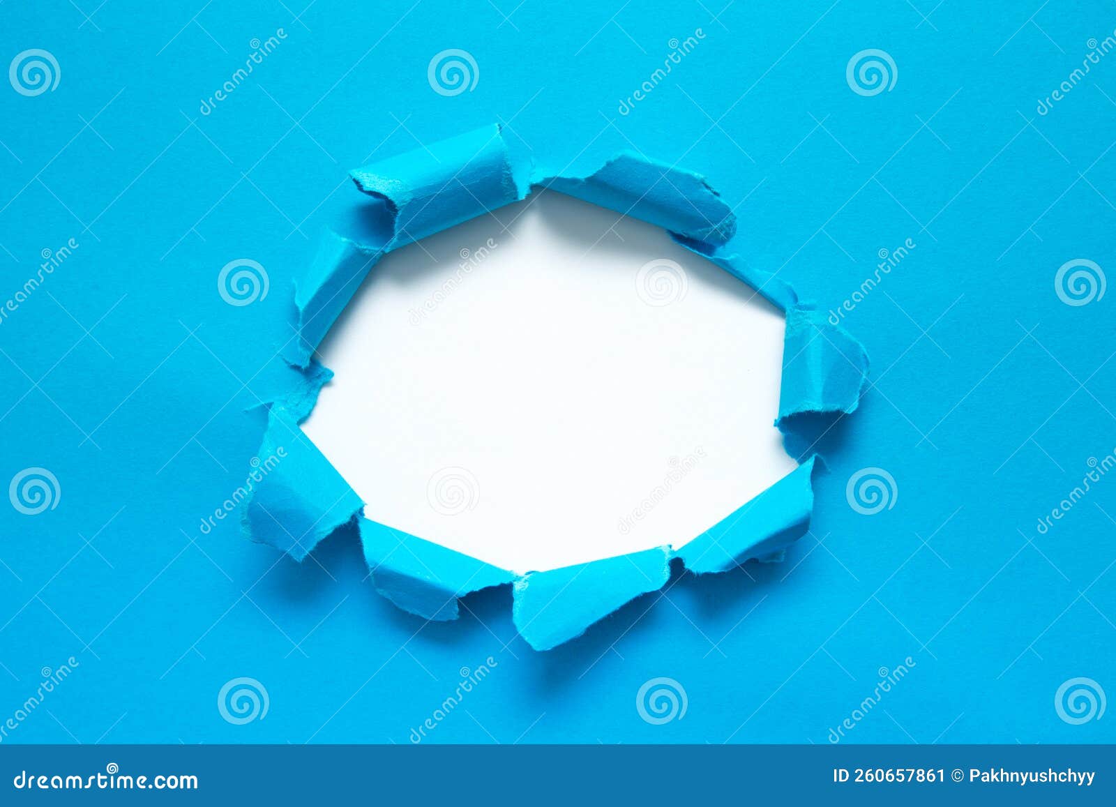 a hole in paper with the sides torn off. torn paper.