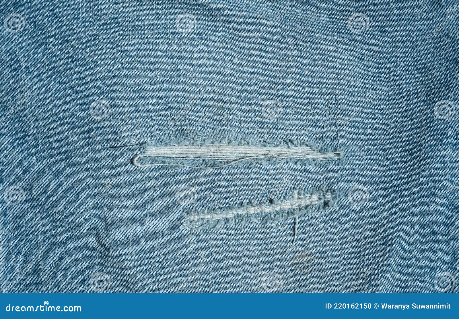 Hole and Threads on Denim Jeans. Ripped Destroyed Torn Blue Jeans