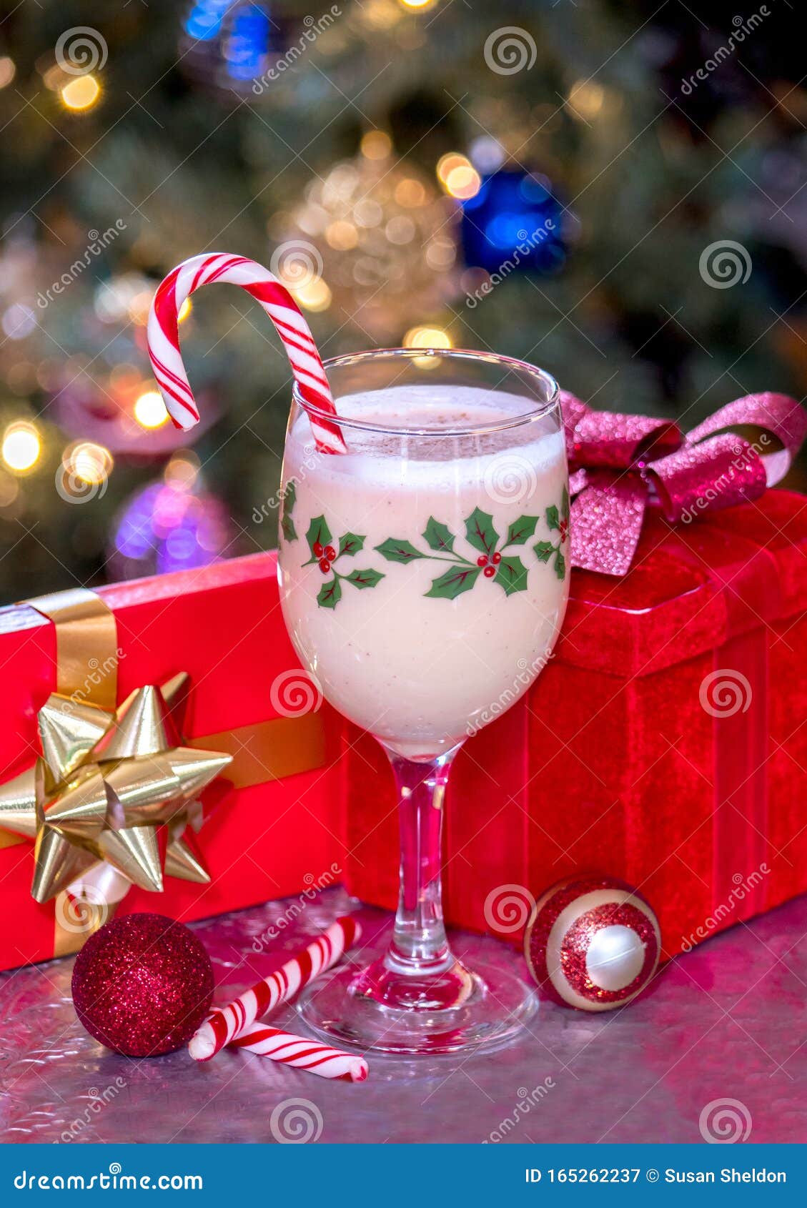 Holiday Gifts and Eggnog with a Candy Cane Stock Image Image of glass