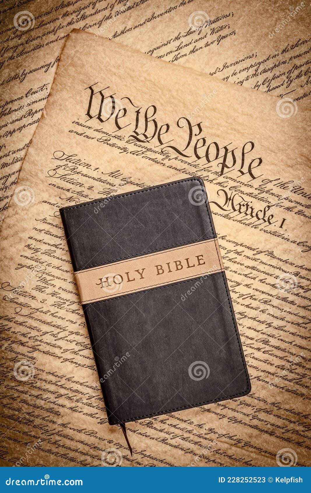 holy bible and small cross on the constitution