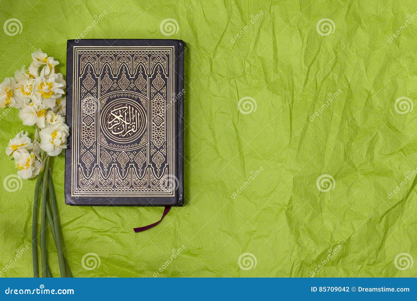Holy Quran and Daffodils Bouquet on Green Craft Paper Background ...
