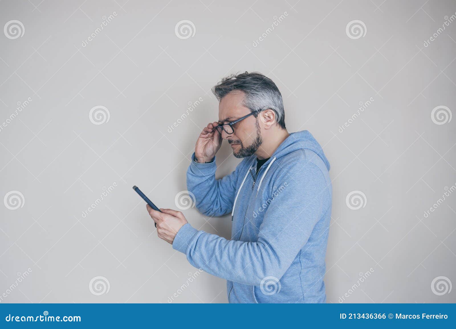 Hombre Con Gafas Con Presbicia Mirando El Teléfono Foto de archivo