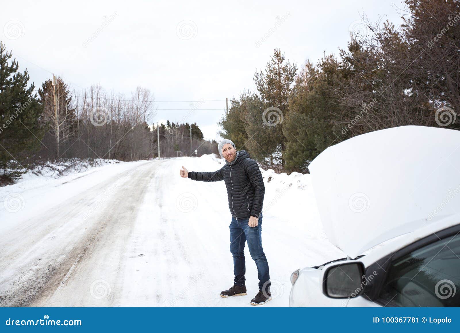 Un hombre en invierno en la calle. el chico camina por la carretera
