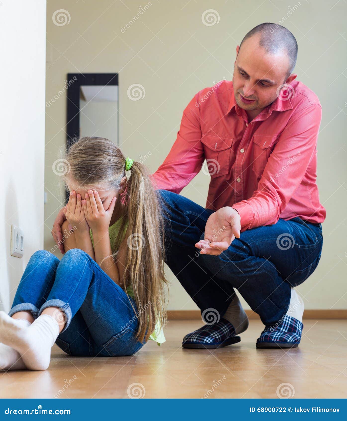 Hombre que da una conferencia a la niña unpleased. Padre serio que da una conferencia a la pequeña hija gritadora ofendida en el interior casero