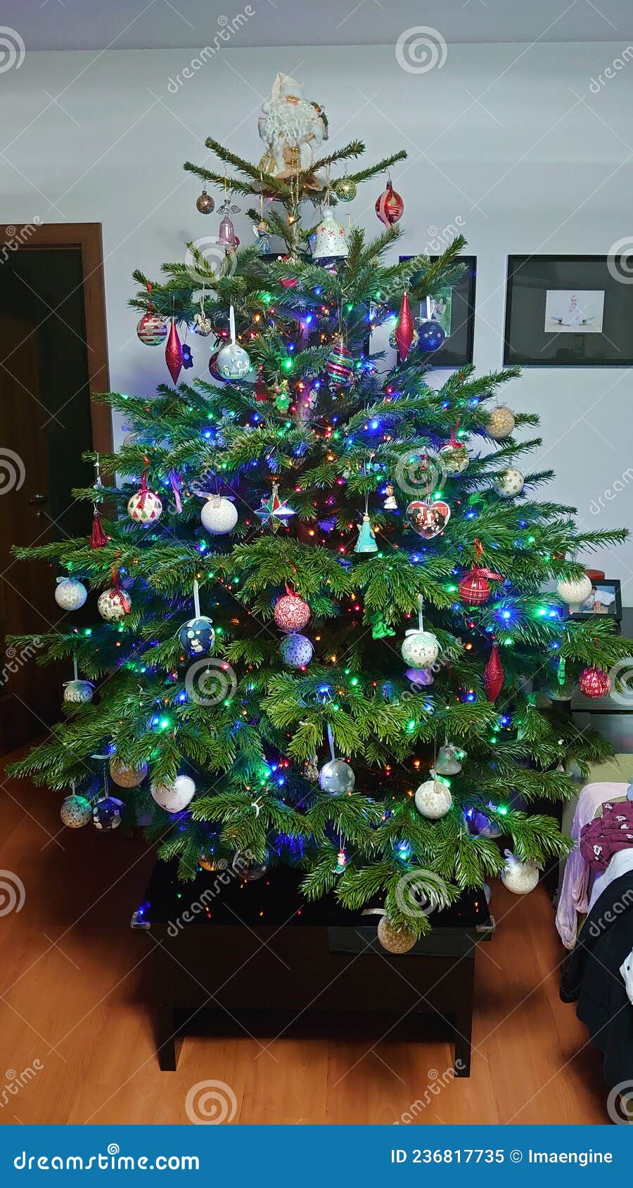 Home Christmas Tree Filled with Colourful Lights and Decorations Stock