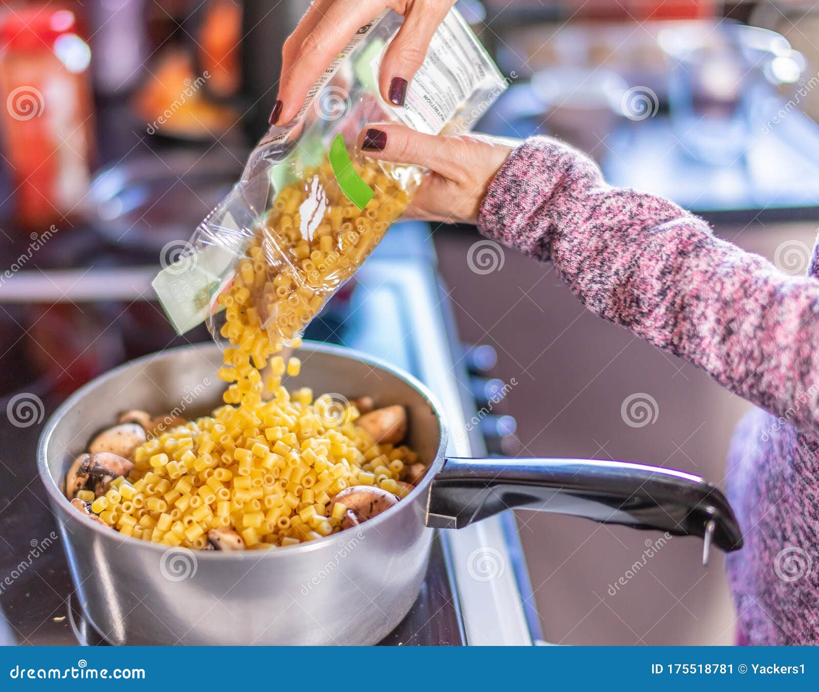 adding dried pasta to a pan of boiling water and mushrooms