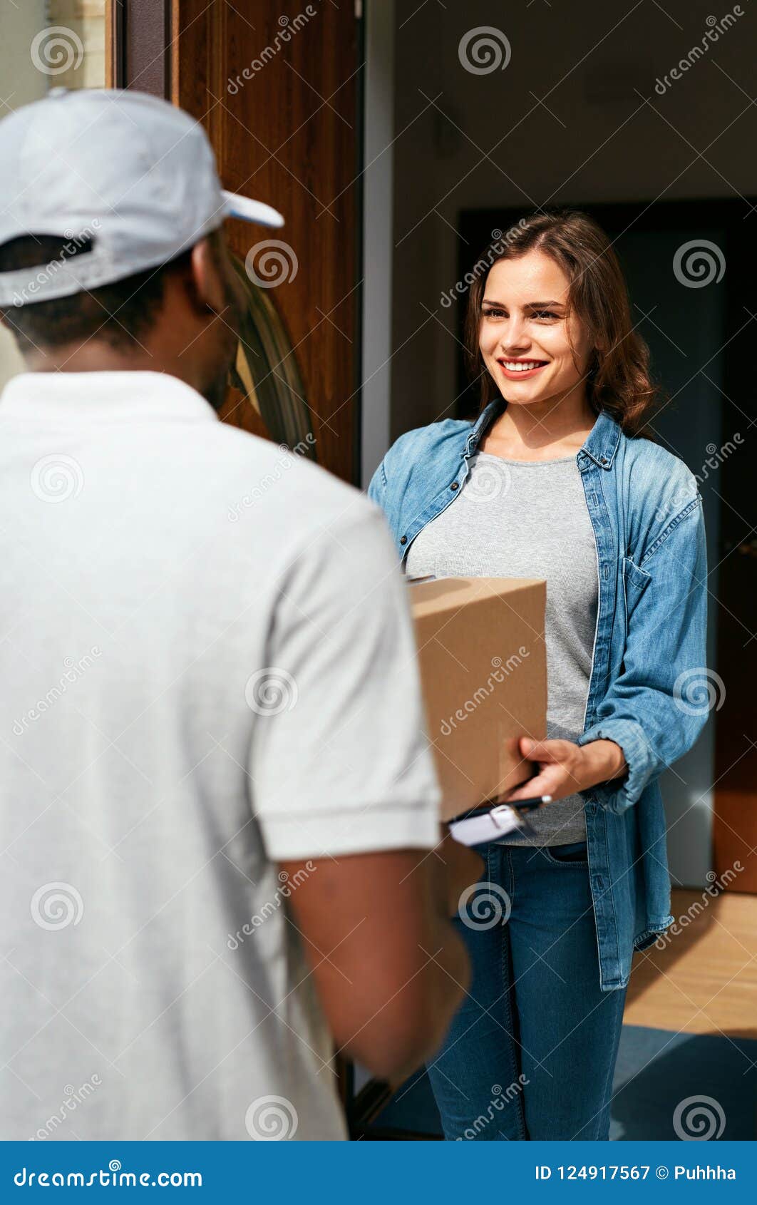 Home Delivery. Courier Delivering Package To Client Stock Image - Image ...