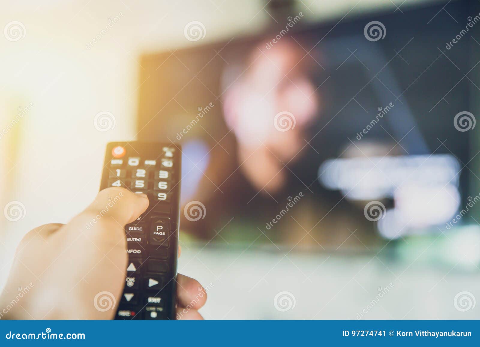 Home Entertainment. Hand Hold Smart TV Remote Control with a Television