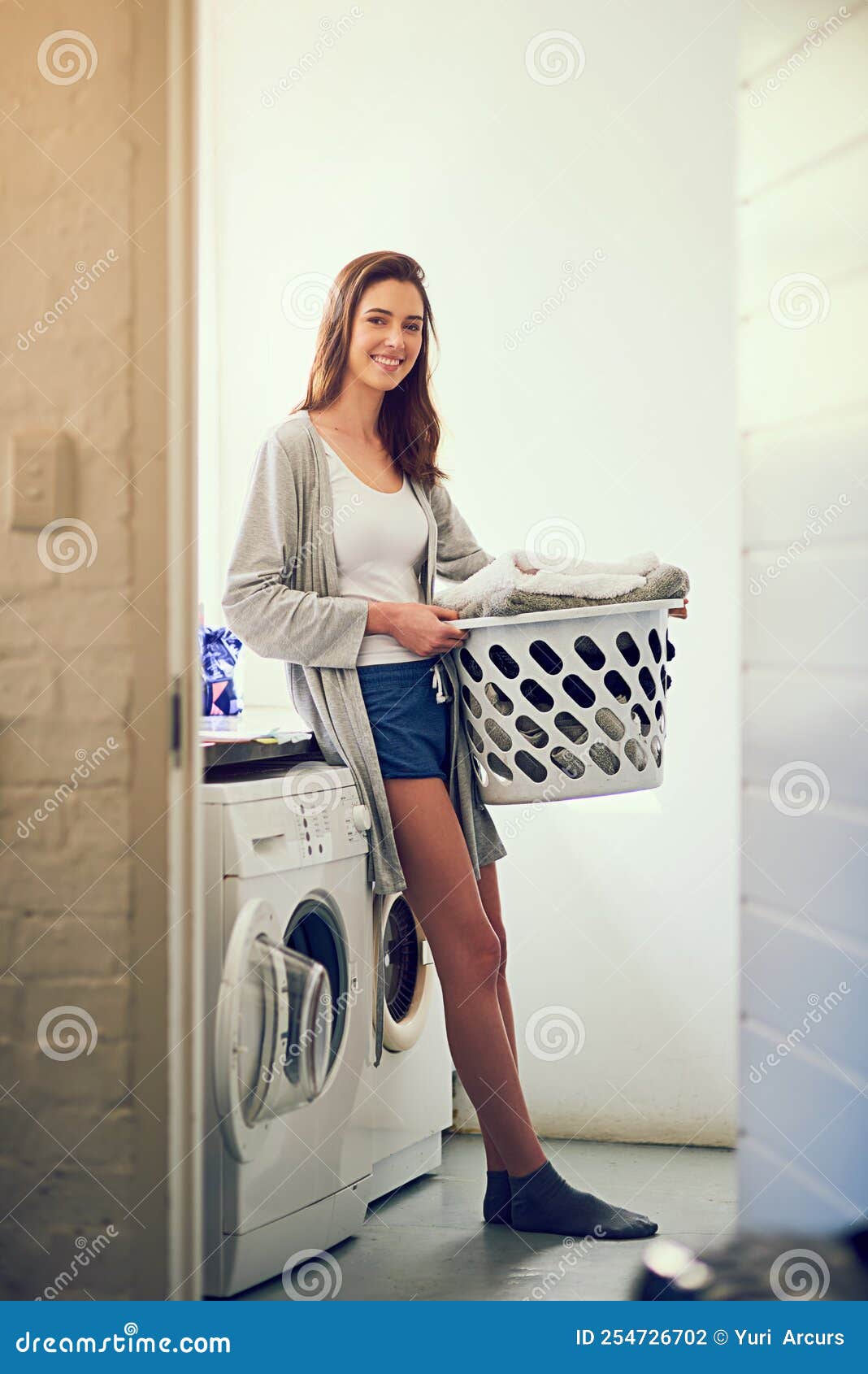 This Home is Full of Love and Laundry. a Young Woman Doing Laundry at