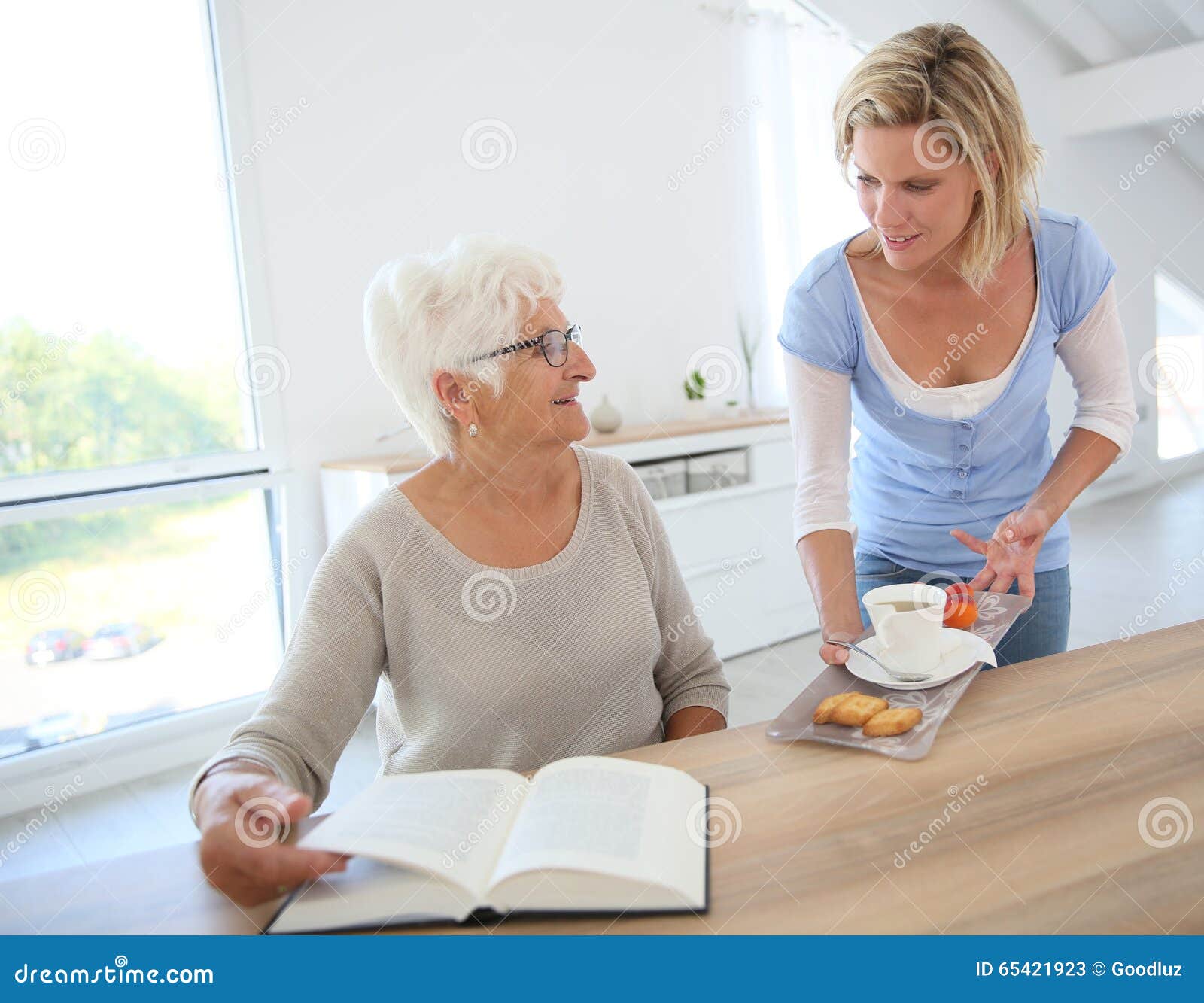 Home Helper Bringing Tea and Cookies To Elderly Stock Image - Image of ...