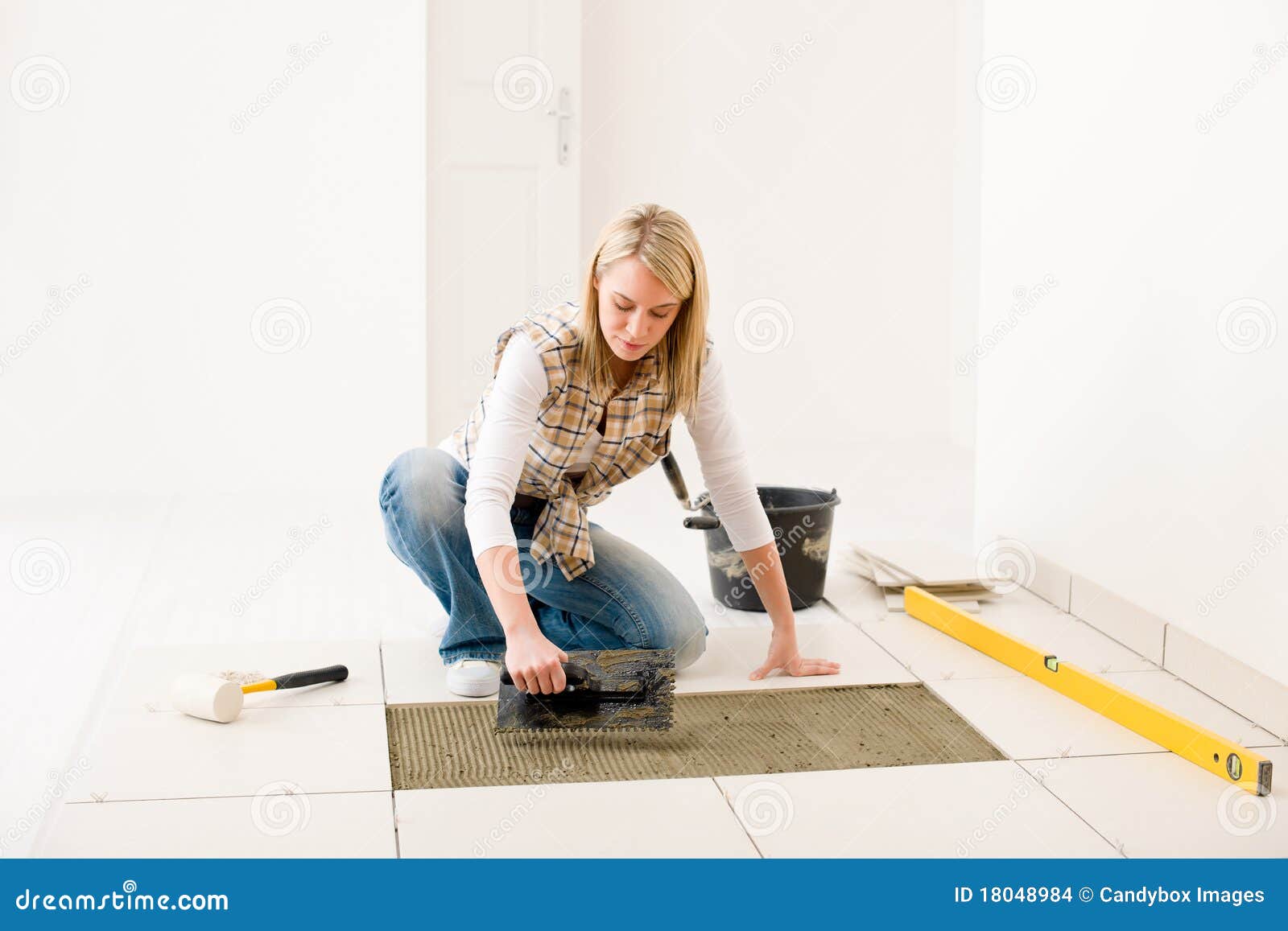 home improvement - handywoman laying tile