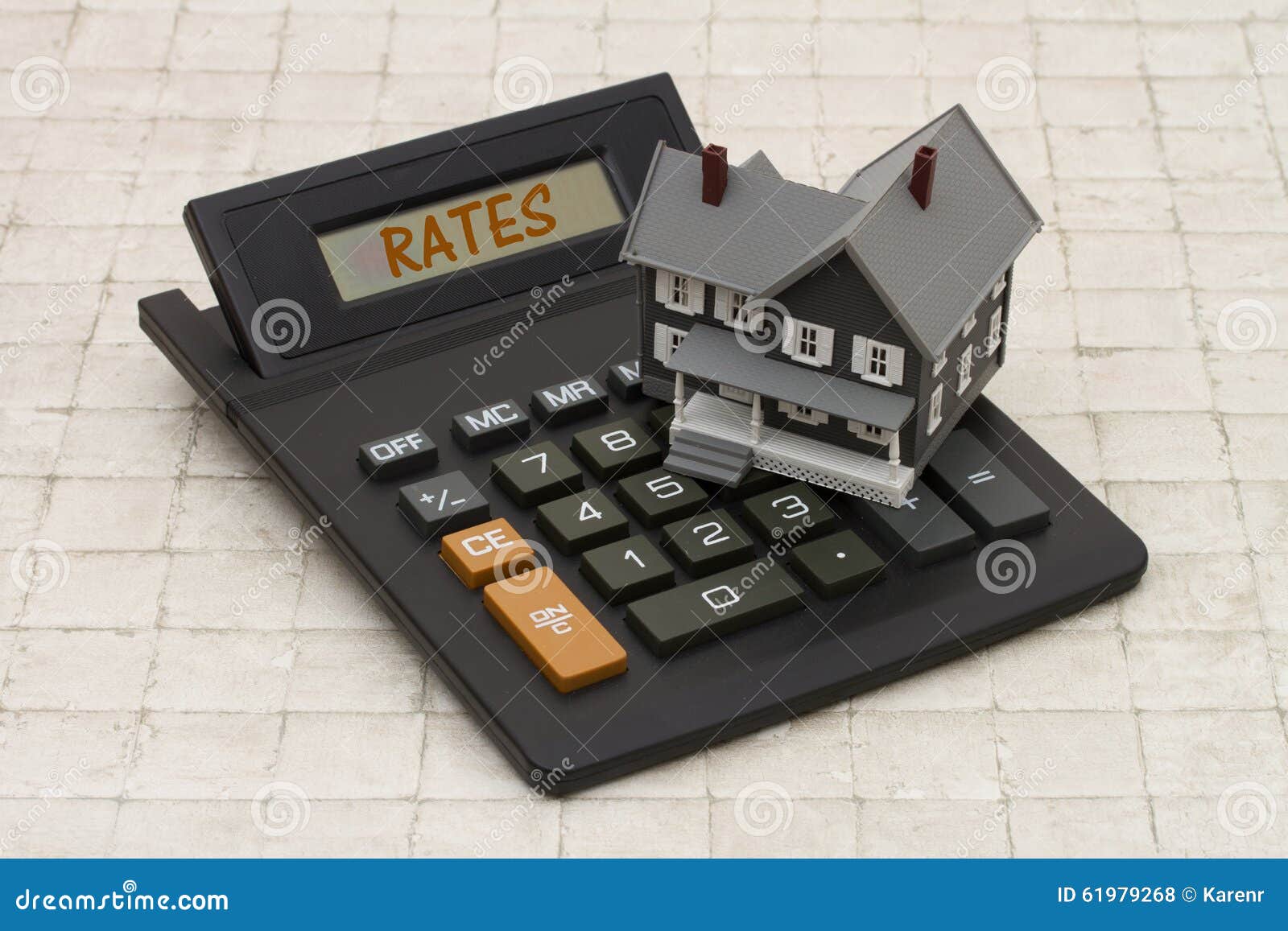 home mortgage interest rates, a gray house and calculator on stone background