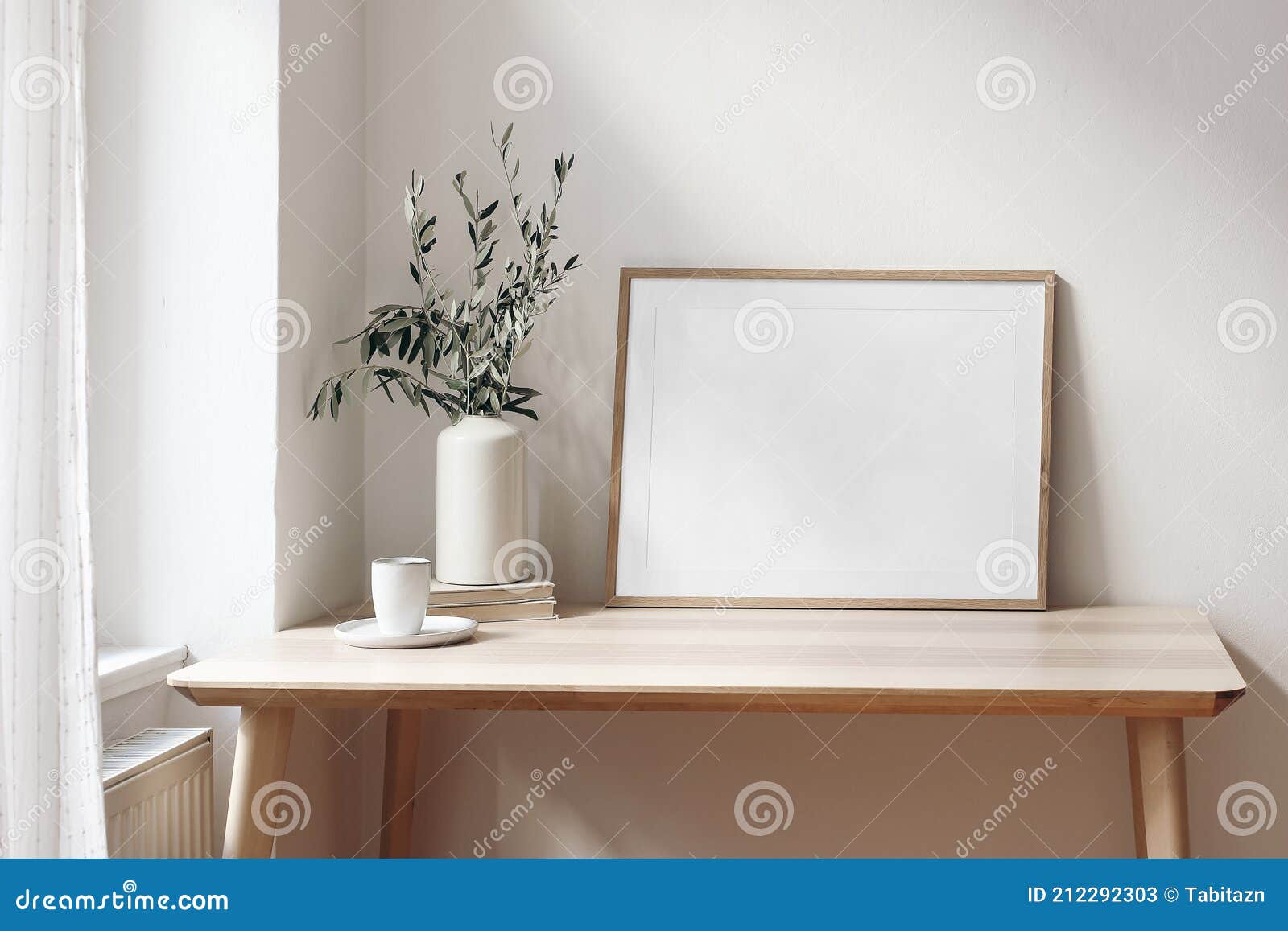 home office concept. empty horizontal wooden picture frame mockup. cup of coffee on wooden table. white wall background