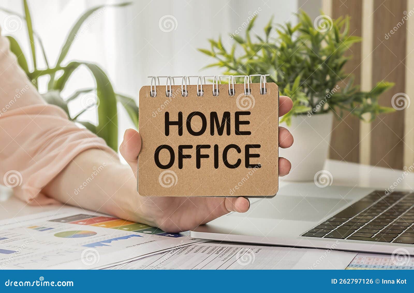 Home Office Text on Sticky Notes in Hand with Office Desk. Stock Photo
