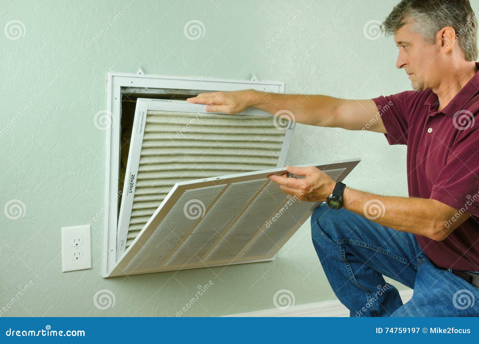 home owner replacing air filter on air conditioner