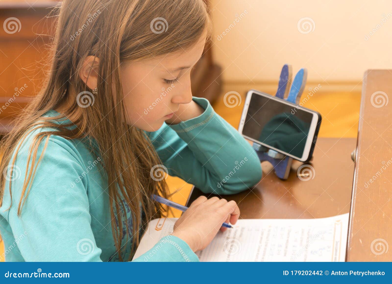 home schooling. schoolgirl studying homework math during her online lesson at home, social distance during quarantine