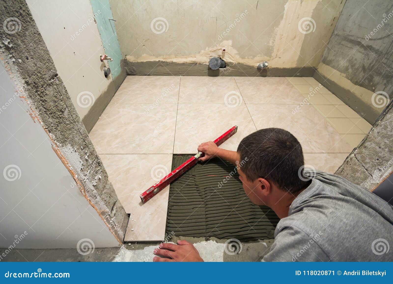 Home Tiles Improvement Handyman With Level Laying Down Tile