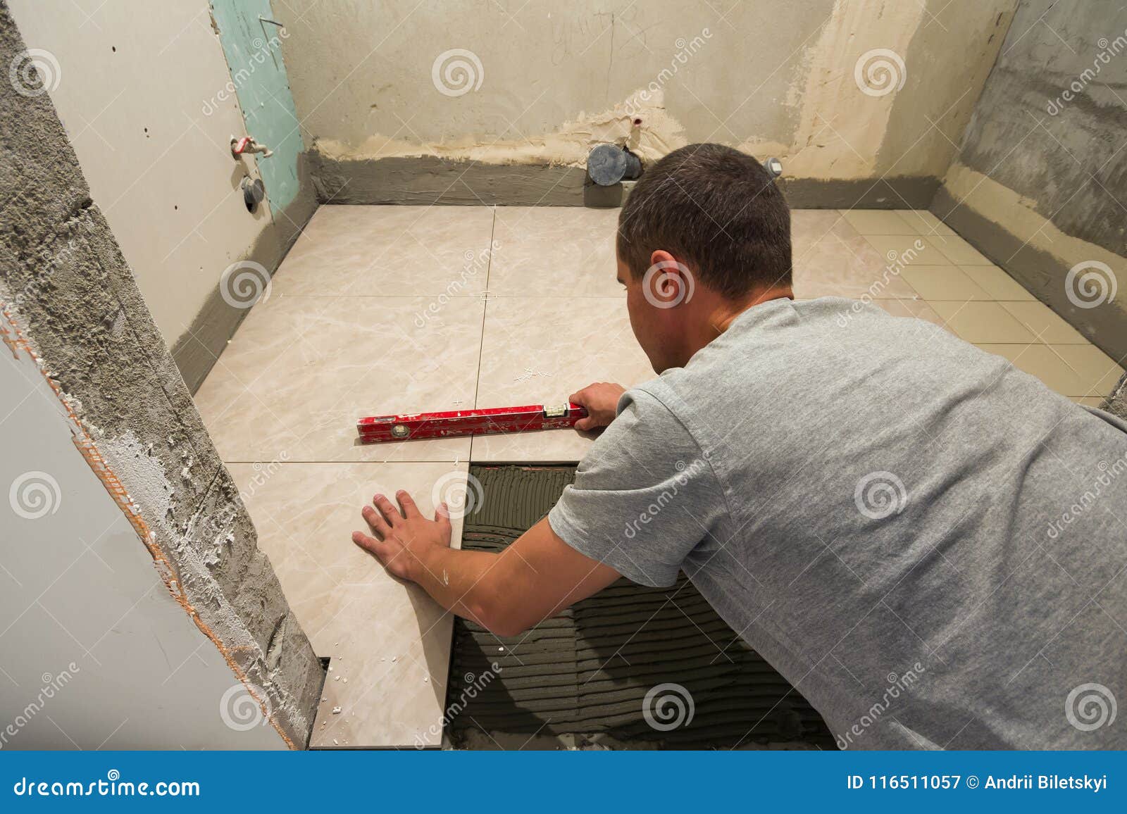 Home Tiles Improvement Handyman With Level Laying Down Tile