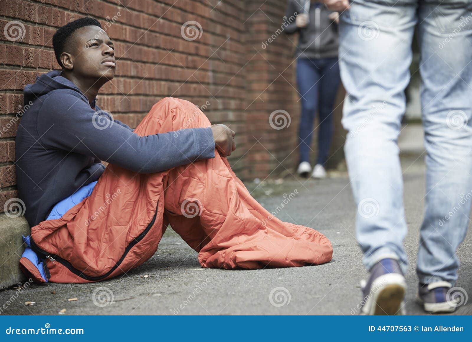 homeless teenage boy sleeping bag on the street