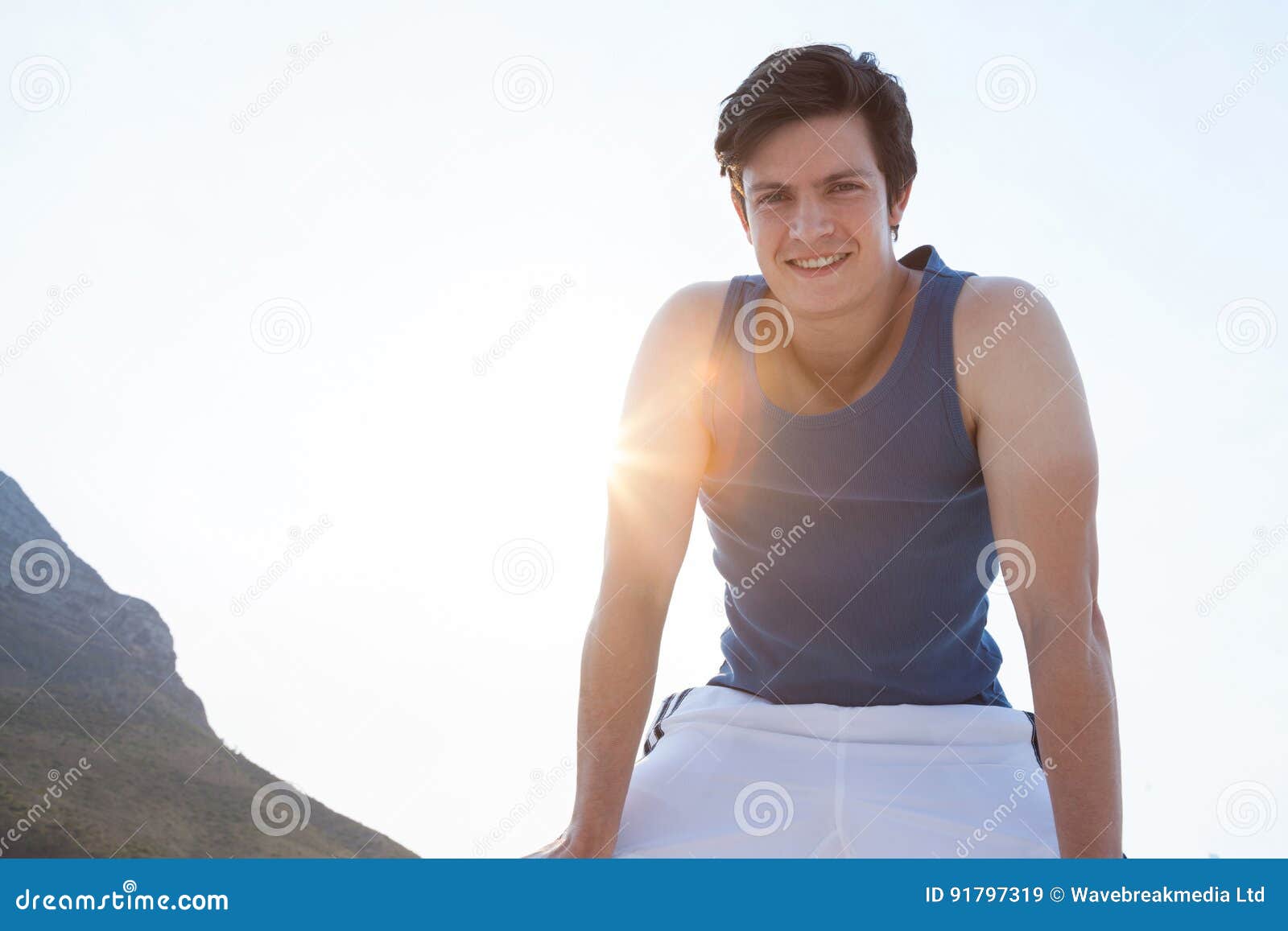Retrato do homem de sorriso que toma a ruptura após movimentar-se na praia
