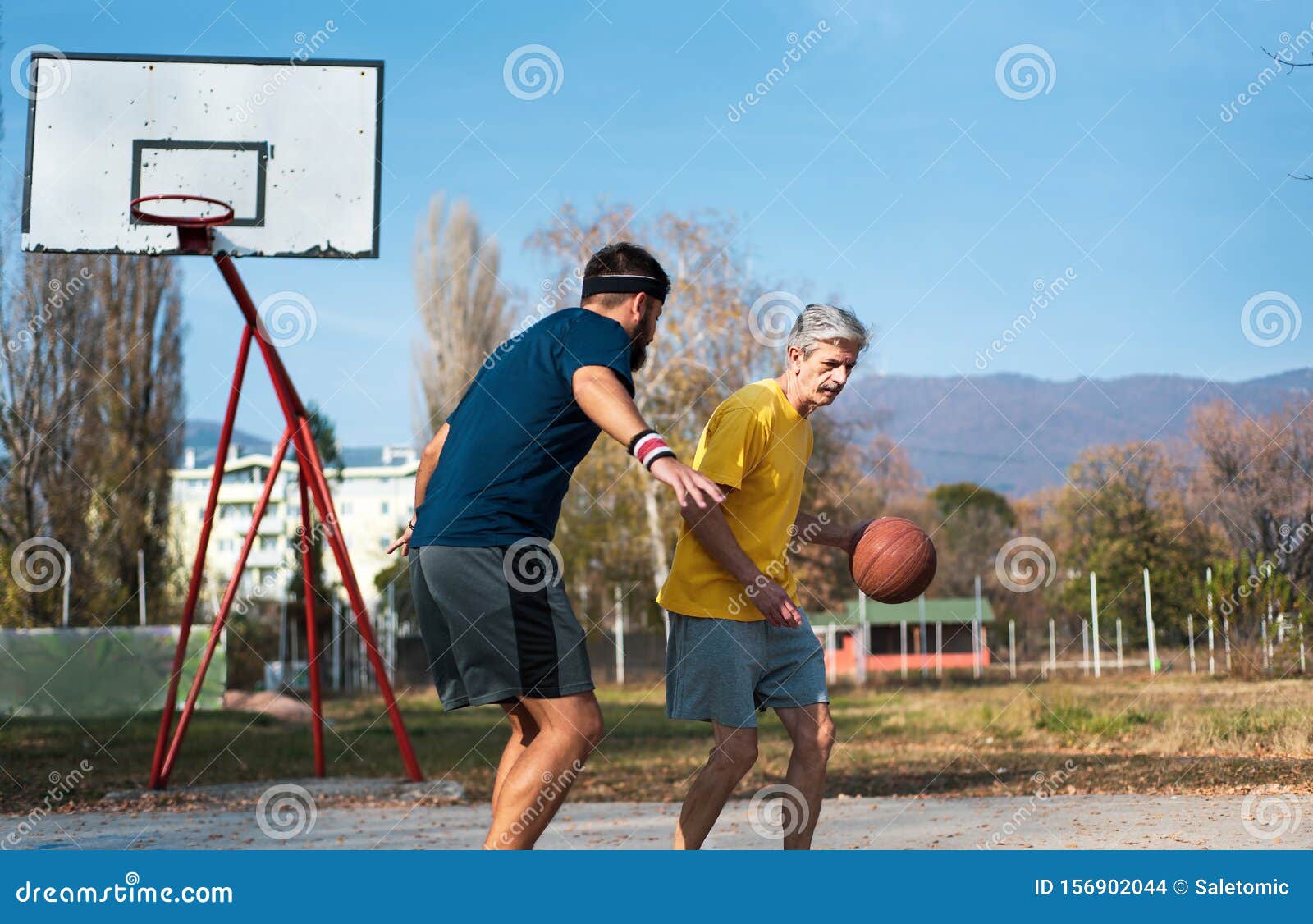 Homem Sênior Jogando Basquete Com Seu Filho Em Um Parque