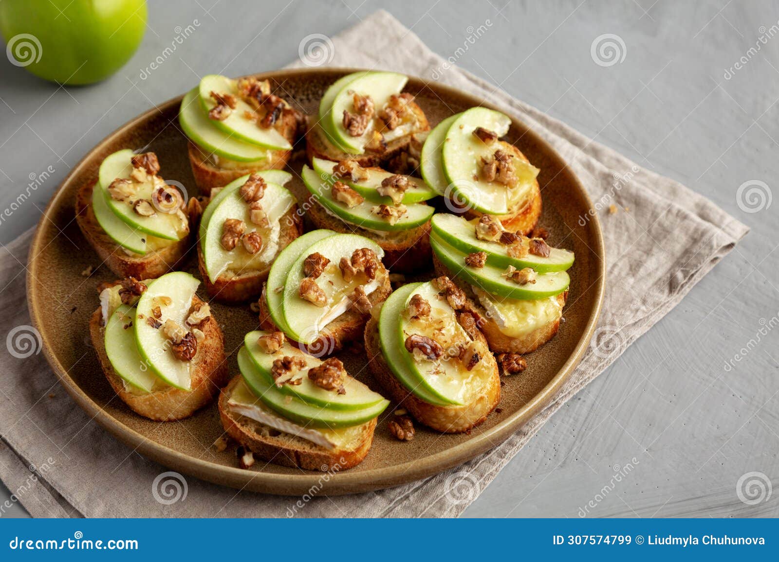 homemade apple brie crostinis on a plate, side view. close-up