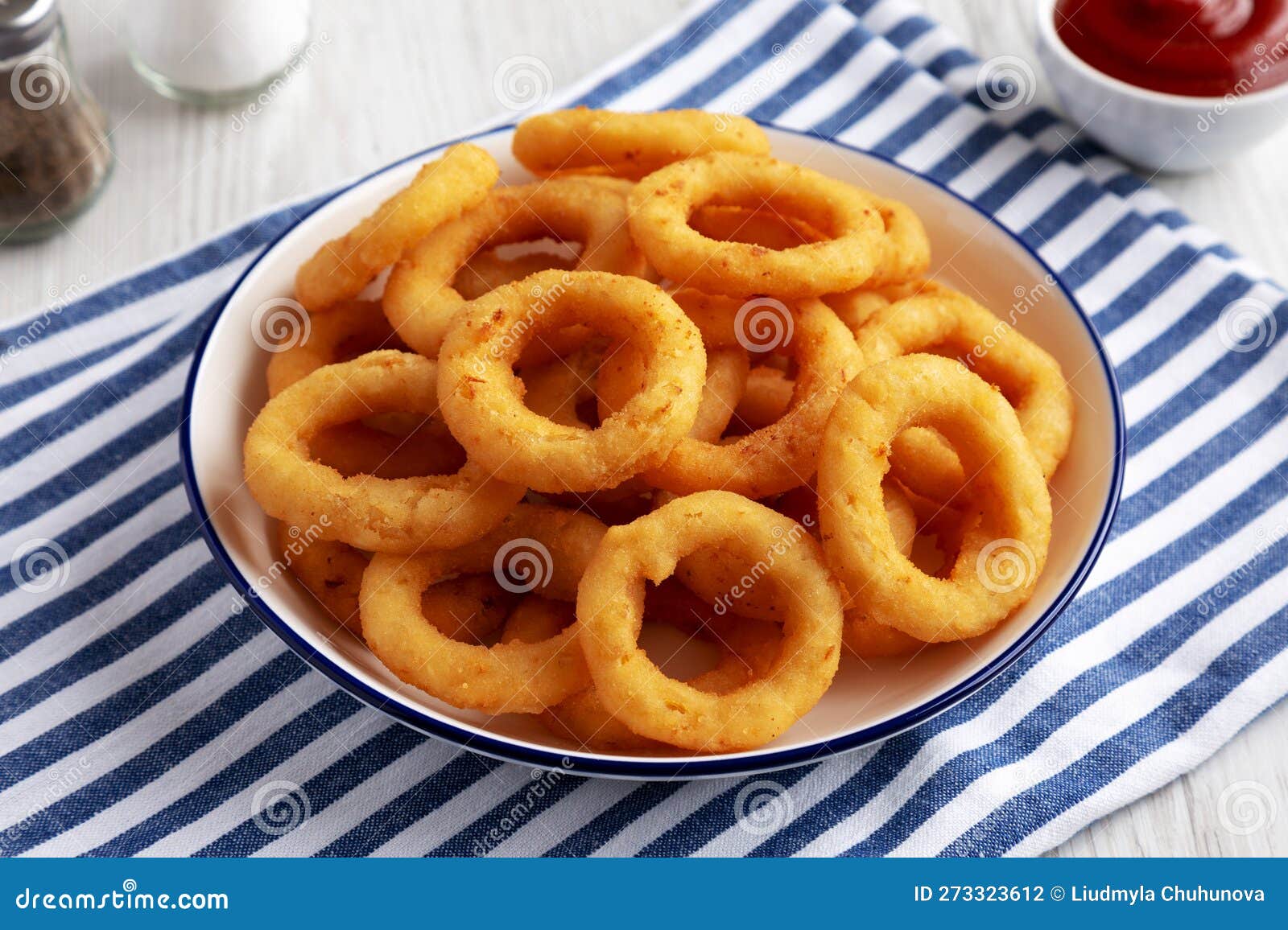 Homemade Breaded Onion Rings with Ketchup on a Plate, Side View Stock