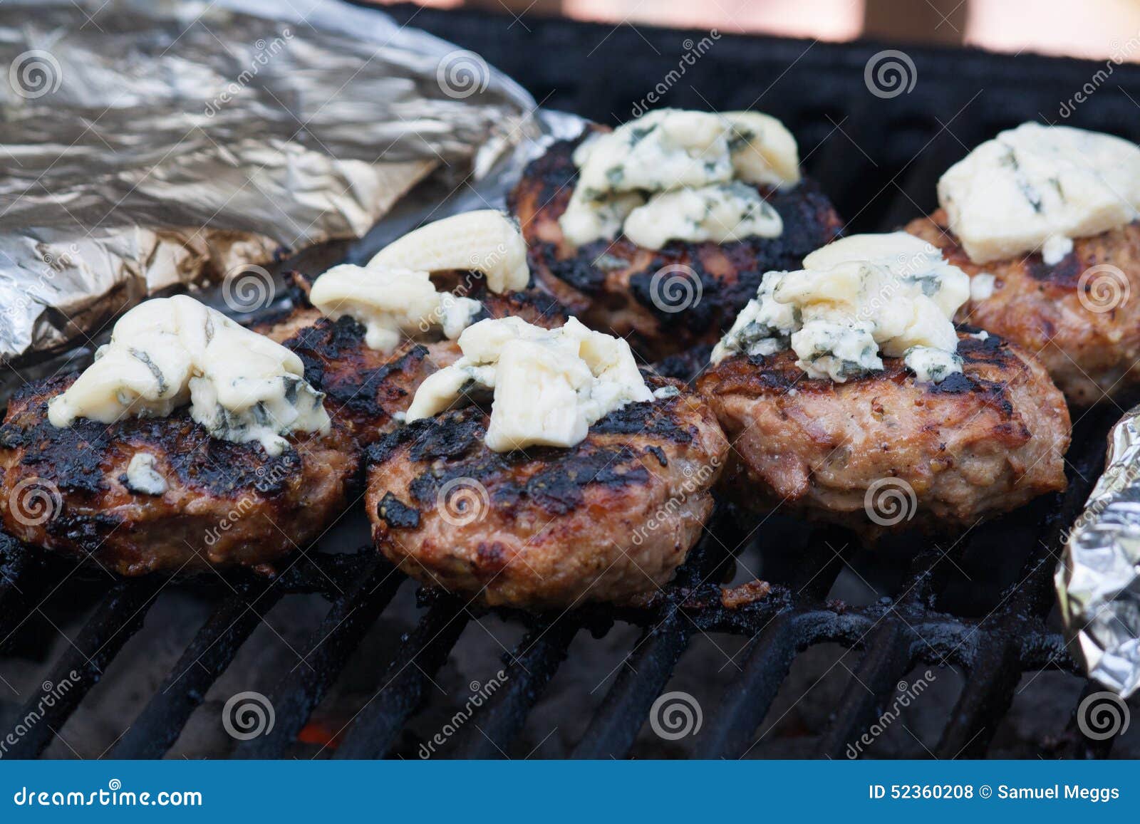 Homemade burgers on the BBQ. Homemade burgers on the barbecue with some blue cheese