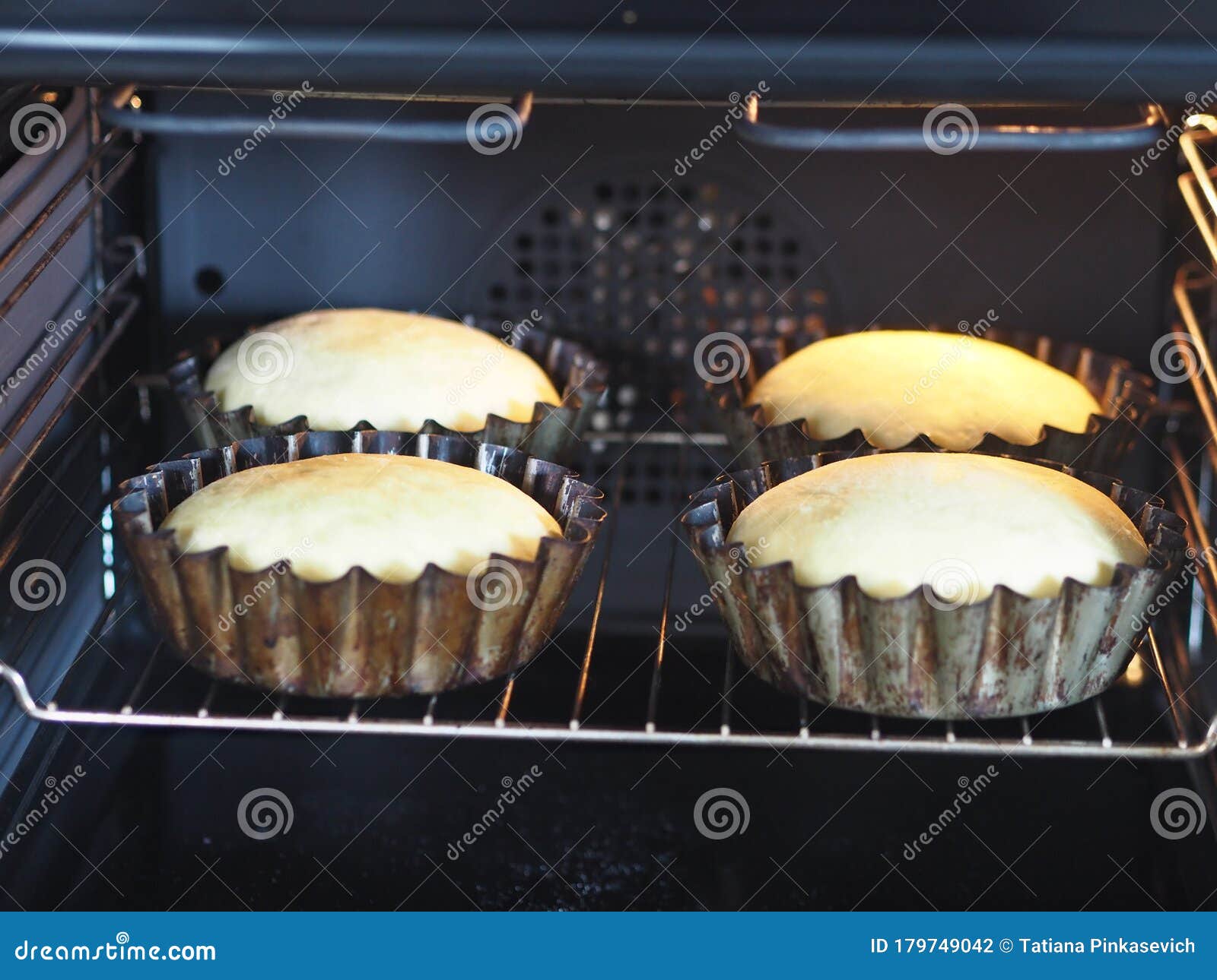 Homemade Cake.Buns are Baked in Baking Pans in the Kitchen Oven Stock
