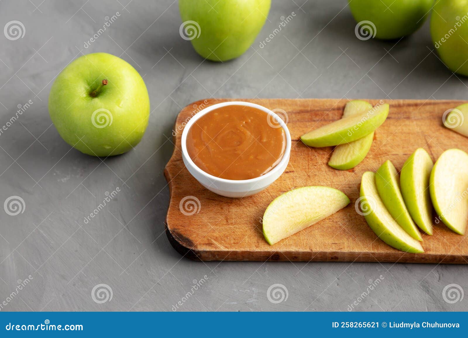 Homemade Caramel Apple Dip on a Rustic Wooden Board, Side View Stock