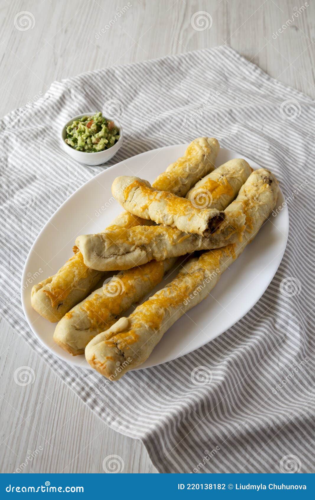 Homemade Cheesy Taco Breadsticks with Guacamole, Low Angle View Stock