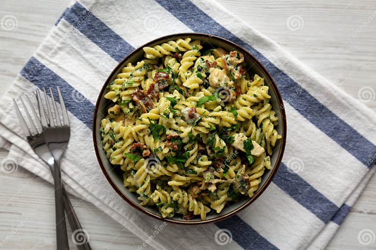 Homemade Chicken Spinach Alfredo Rotini Pasta in a Bowl, Top View. Flat