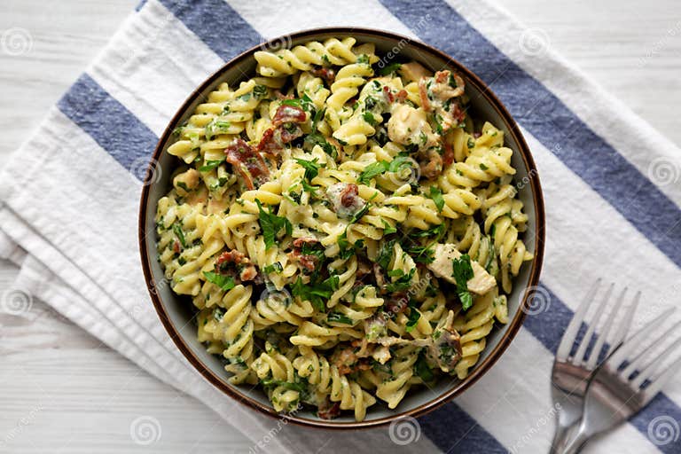 Homemade Chicken Spinach Alfredo Rotini Pasta in a Bowl, Top View. Flat