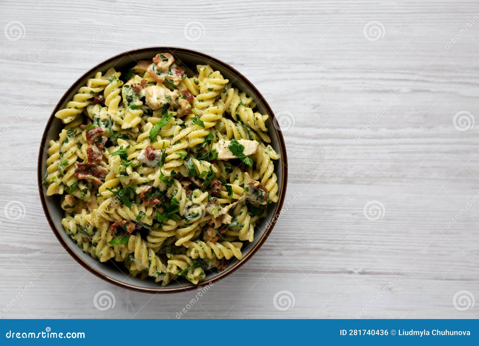 Homemade Chicken Spinach Alfredo Rotini Pasta in a Bowl, Top View. Flat