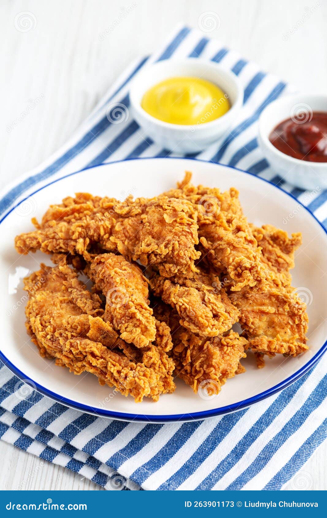 Homemade Chicken Strips with Mustard and BBQ on a Plate, Side View