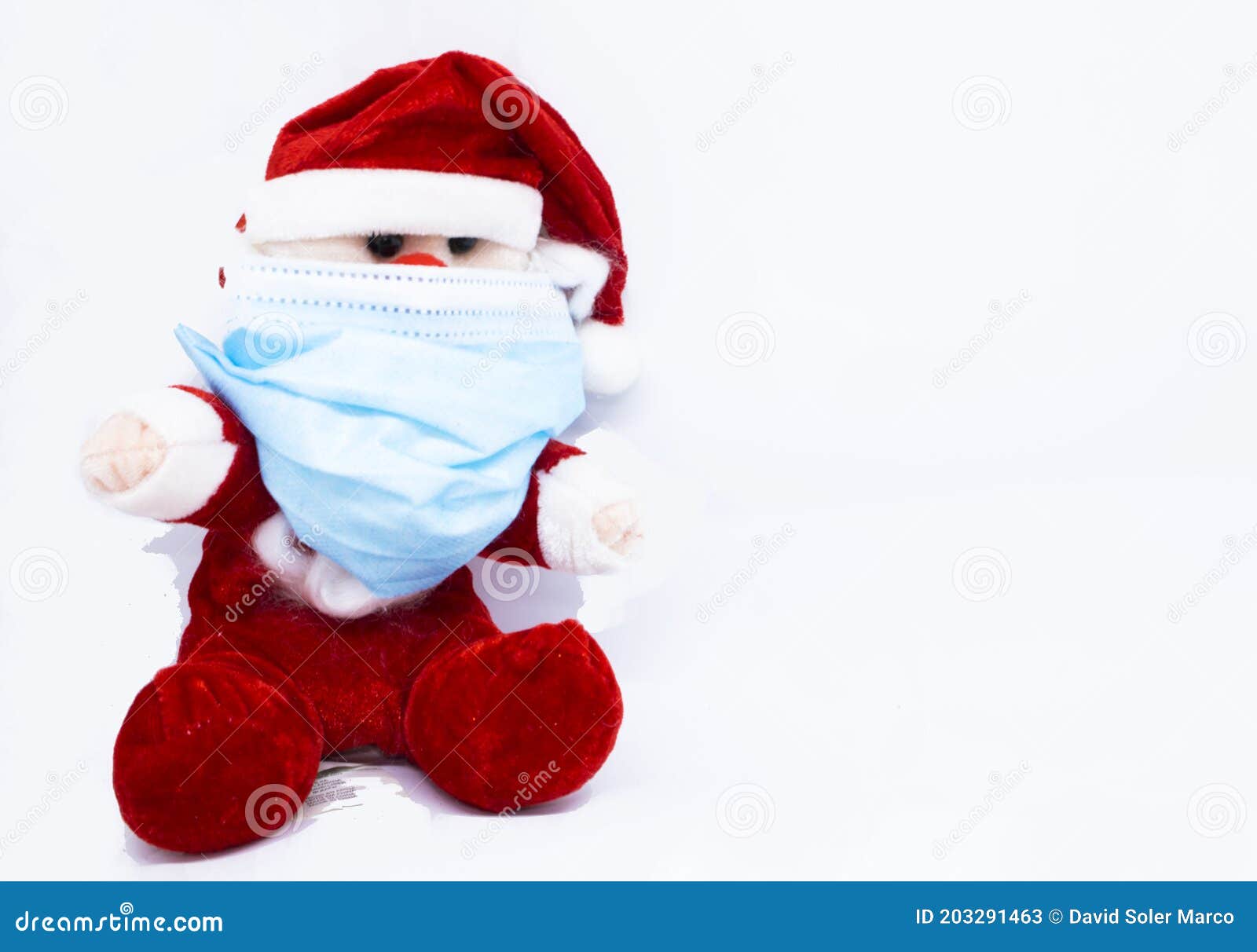 homemade cotton santa claus play with a covid-19 or coronavirus protection mask