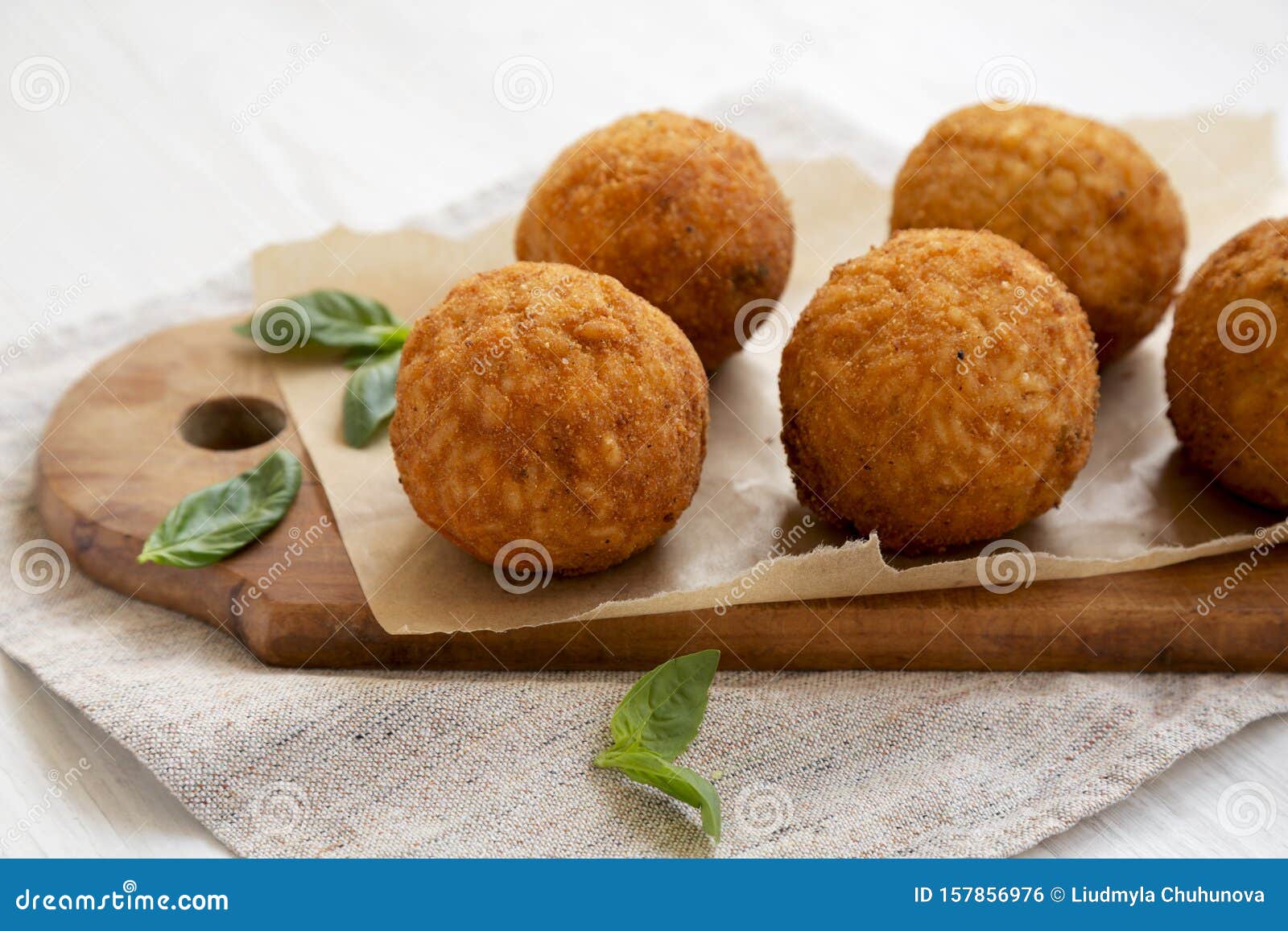 Homemade Fried Arancini With Basil On A White Wooden Background Side