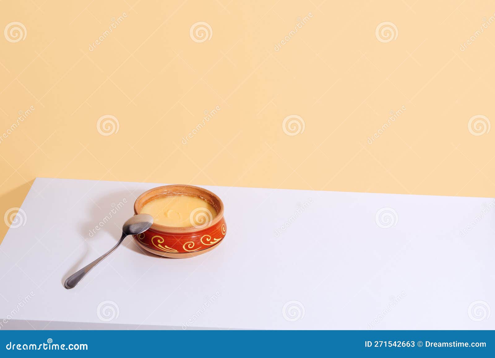 Homemade Ghee in a Ceramic Pot on a White Table. Ayurveda Stock Image