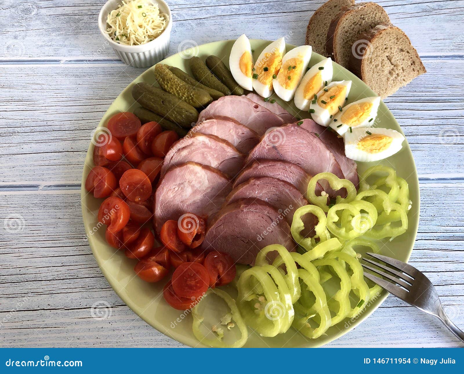 homemade holiday ham with side dishes on wooden background.