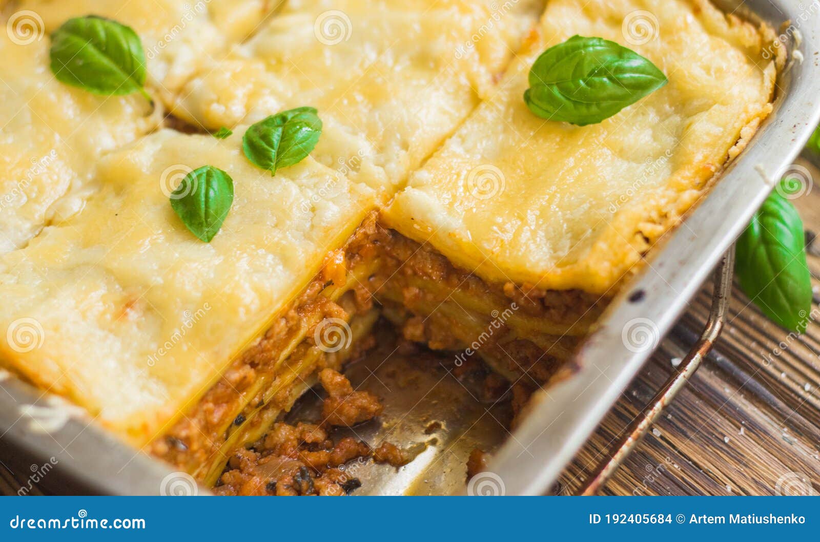 Homemade Lasagna Ready To Eat in Metal Baking Tray Served with Basil ...