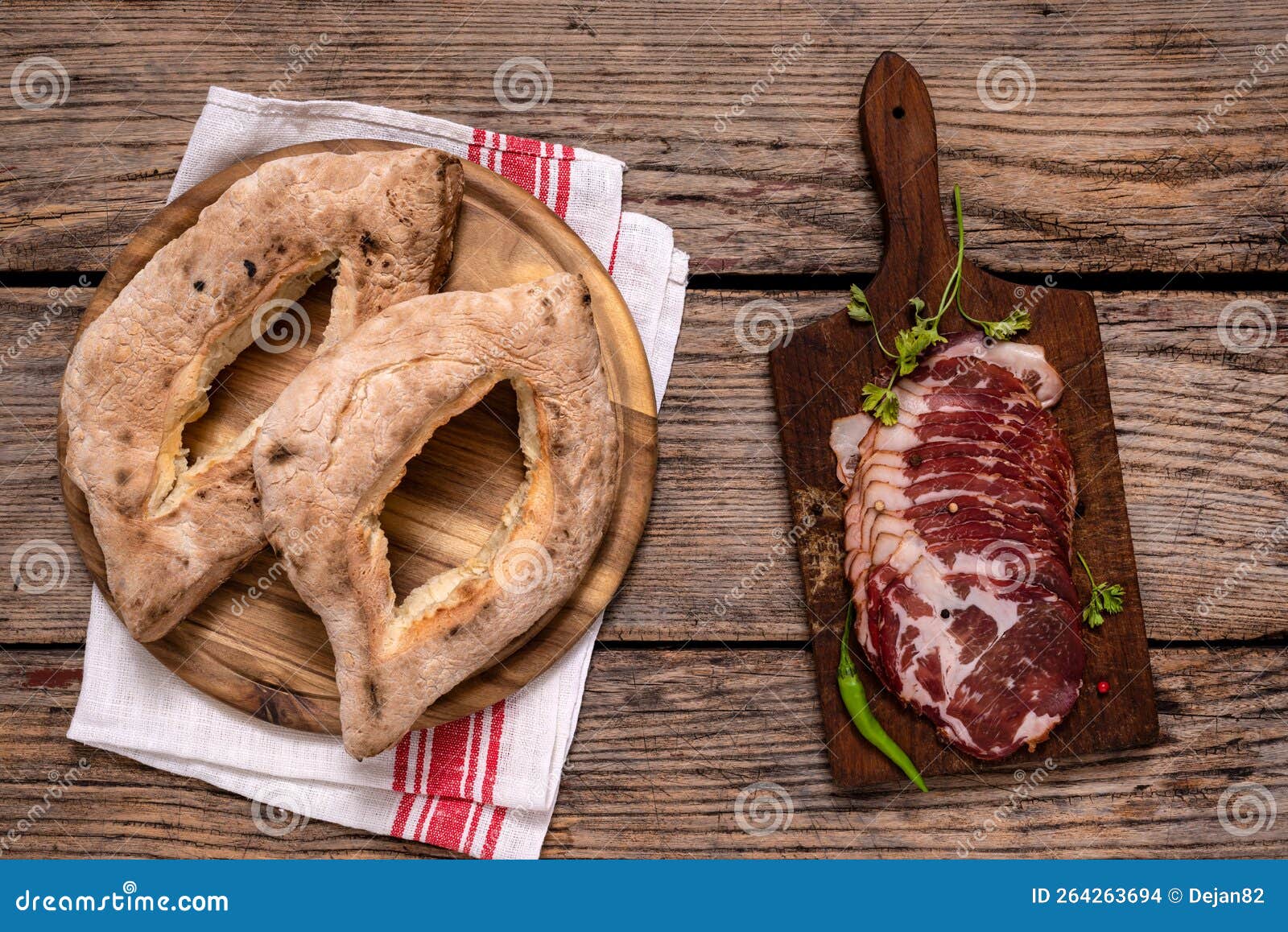 homemade lepinja bread and appetizer on wooden background