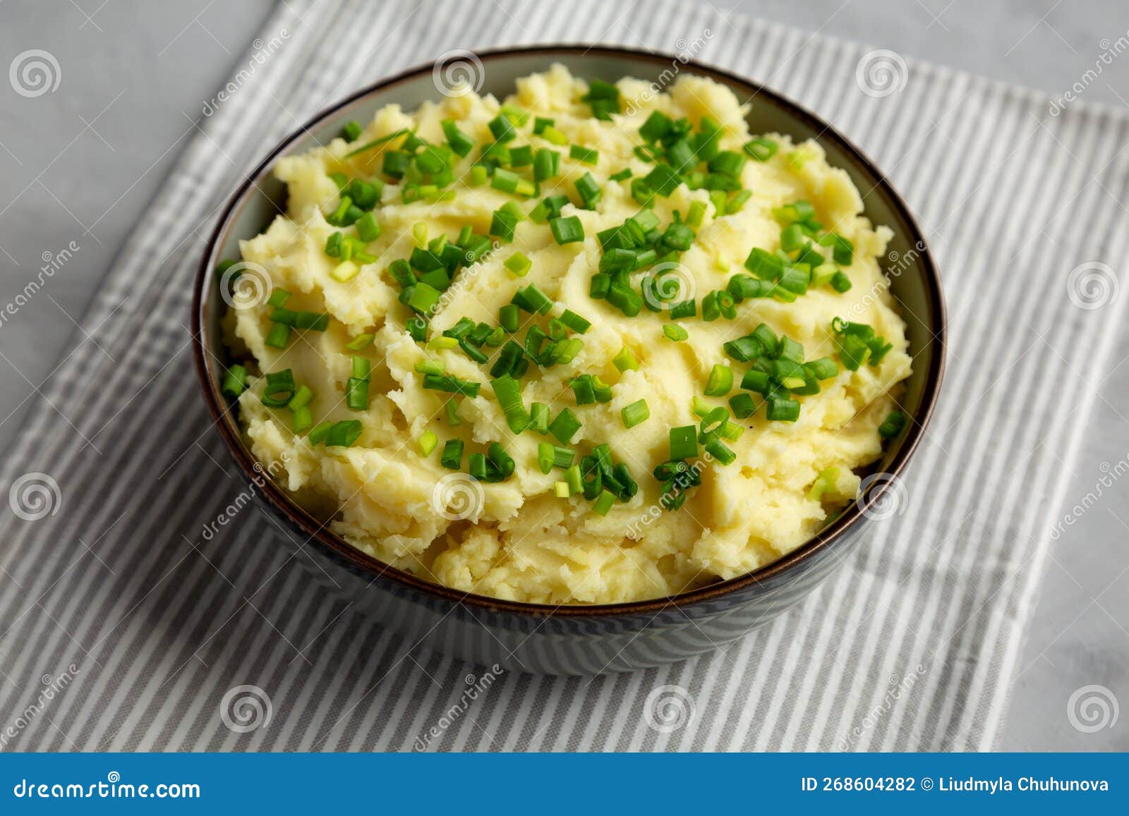 Homemade Mashed Potatoes with Chives in a Bowl, Side View Stock Photo