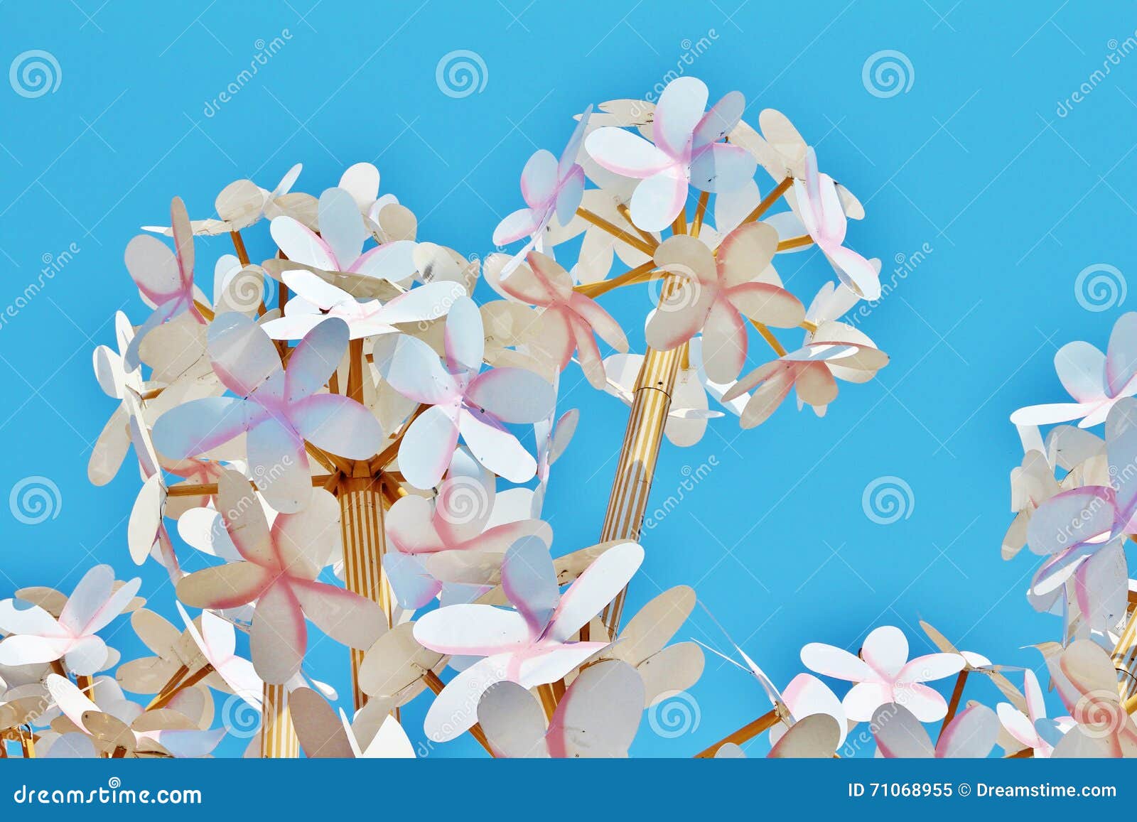 homemade paper flowers on a background of bright blue sky
