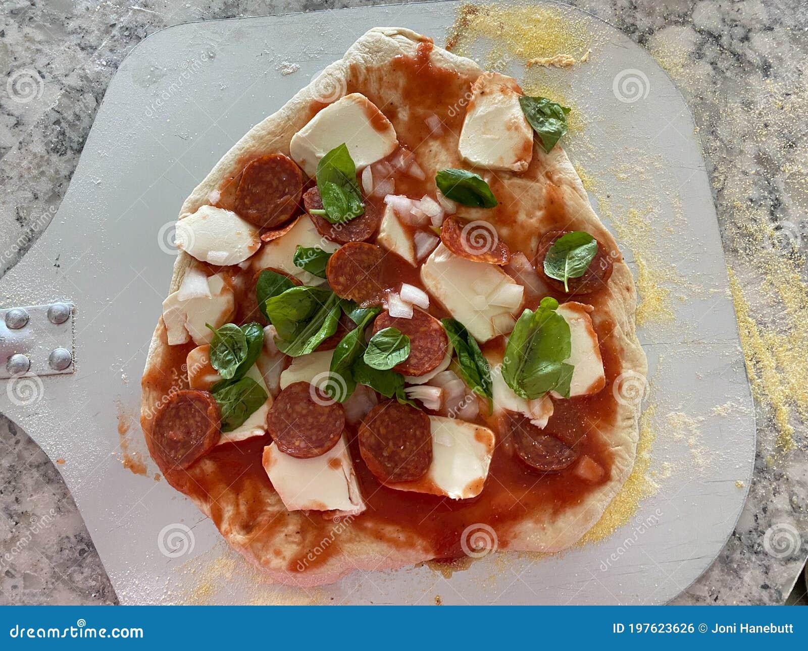 Homemade Pizza on a Pizza Peel in a Kitchen Stock Photo Image of