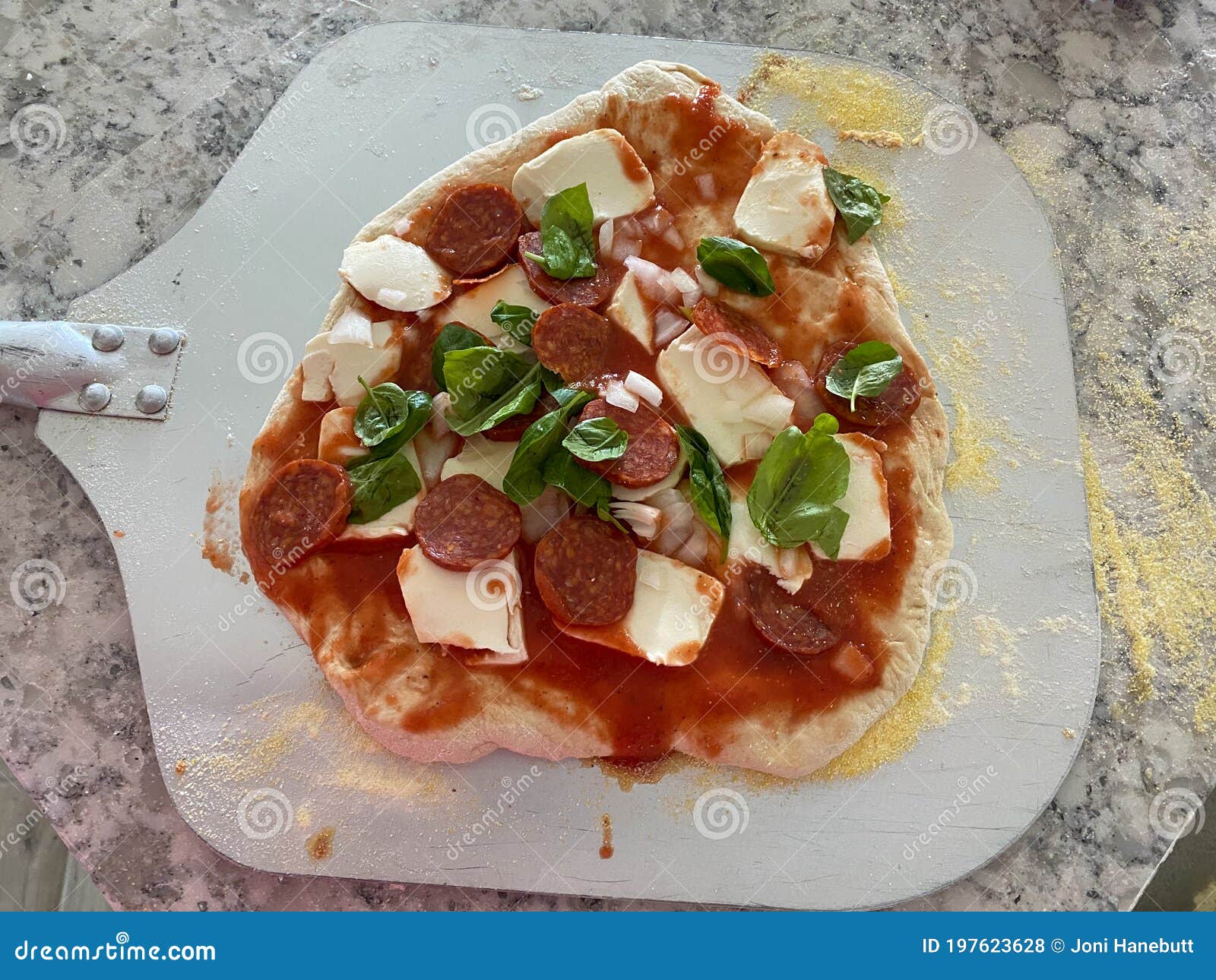 Homemade Pizza on a Pizza Peel in a Kitchen Stock Photo Image of