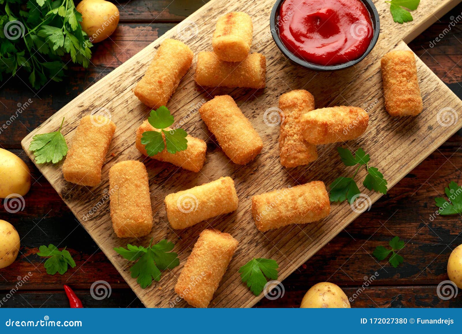 homemade potato croquettes with dipping sauce on wooden board