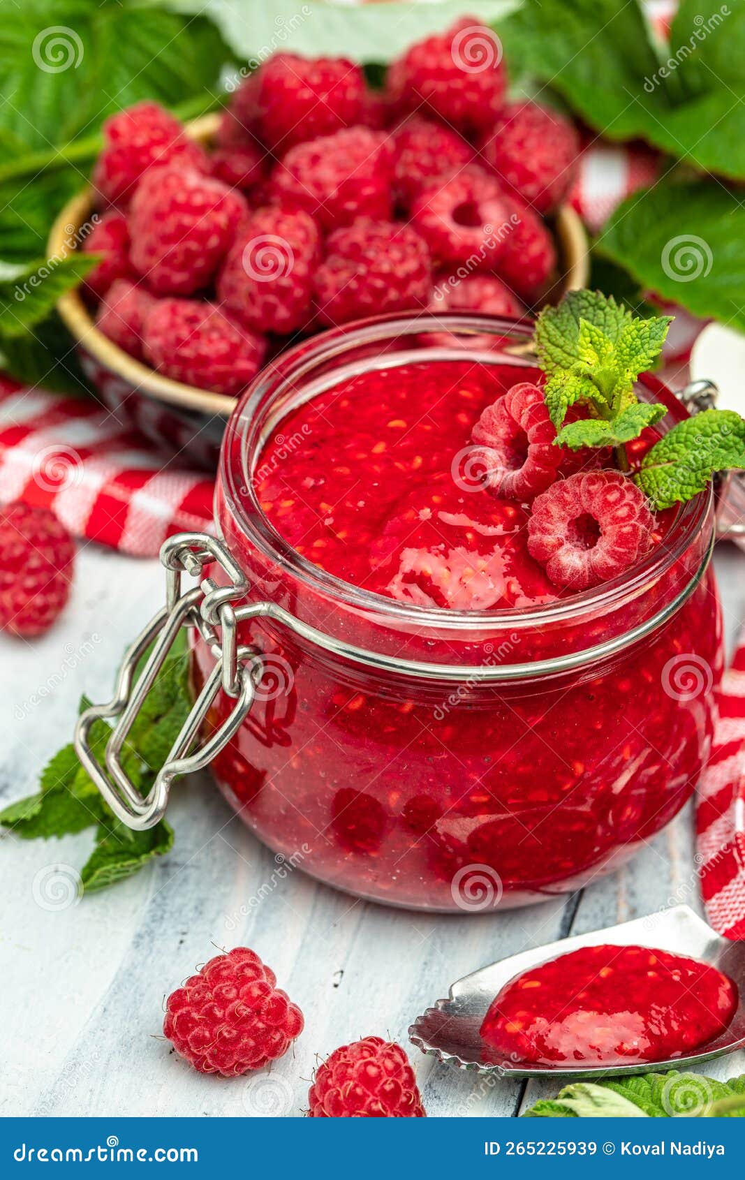 Homemade Raspberry Jam in Jar with Raspberries and Mint. Vertical Image