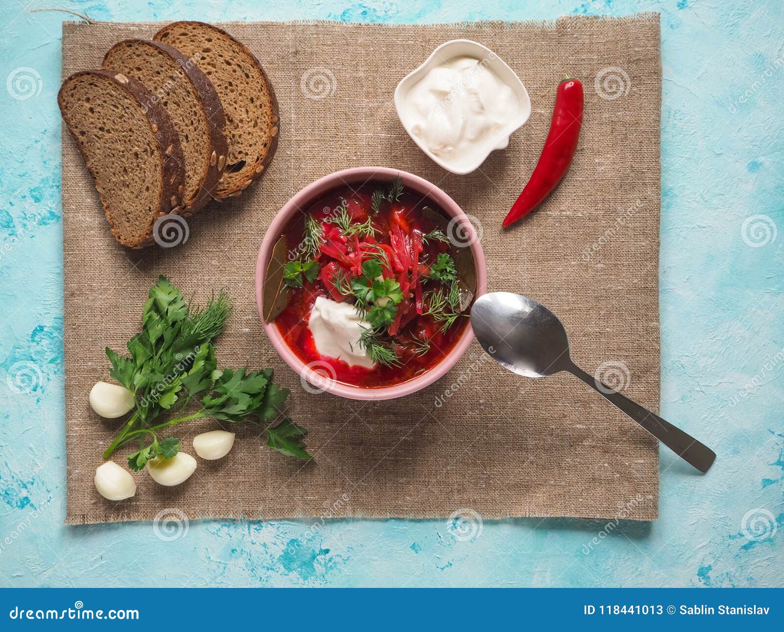 Homemade Russian, Ukrainian and Polish national soup - red borscht made of beetrot, vegetables and meat with sour cream.