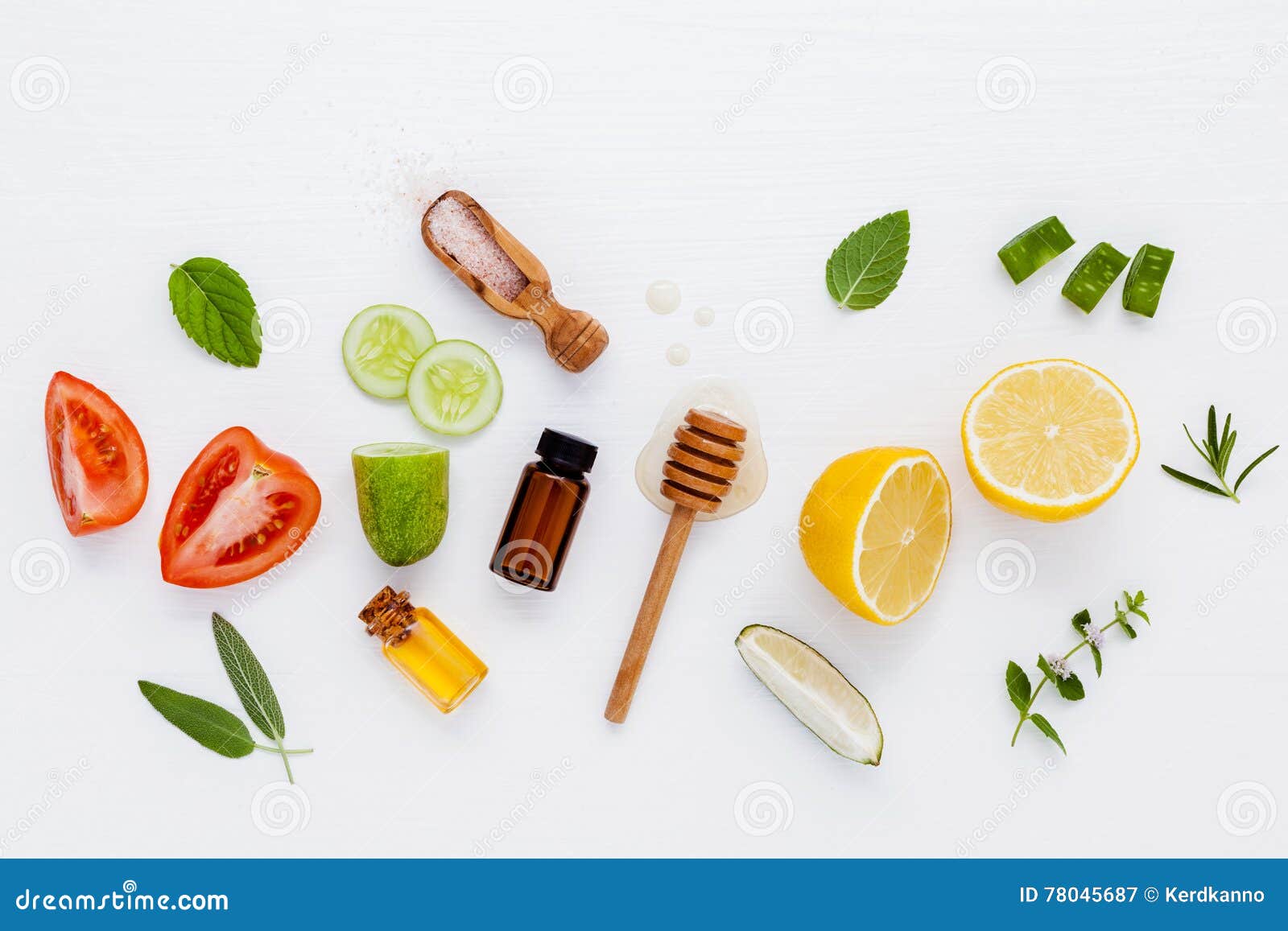 Homemade skin care and body scrubs with natural ingredients aloe vera ,lemon,cucumber ,himalayan salt ,tomato,mint ,lime slice,rosemary and honey set up on white wooden background with flat lay.