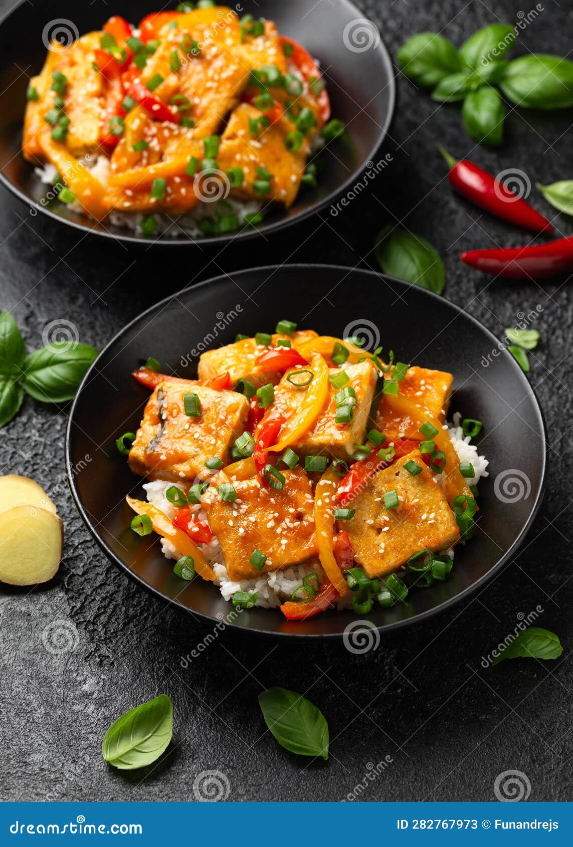 Homemade Stir Fry Tofu with Vegetables and Rice in Black Bowl. Stock